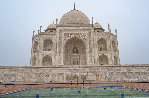 The Taj Mahal as seen on a late afternoon with the smoggy air quality typical of December in Agra, India.