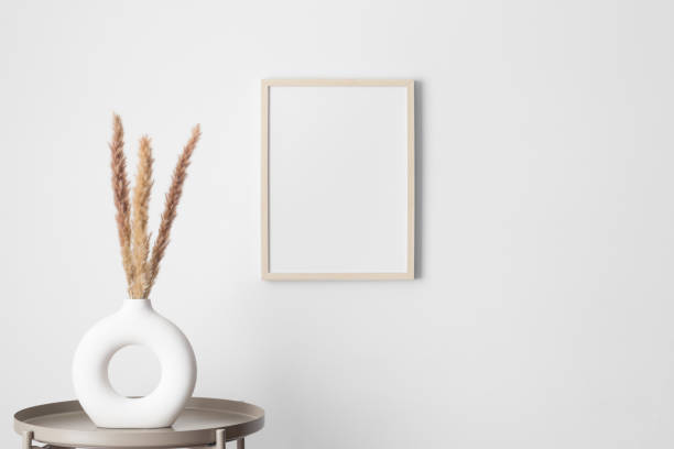 istock Wooden frame mockup on the wall with a pampas decoration. 2013247748