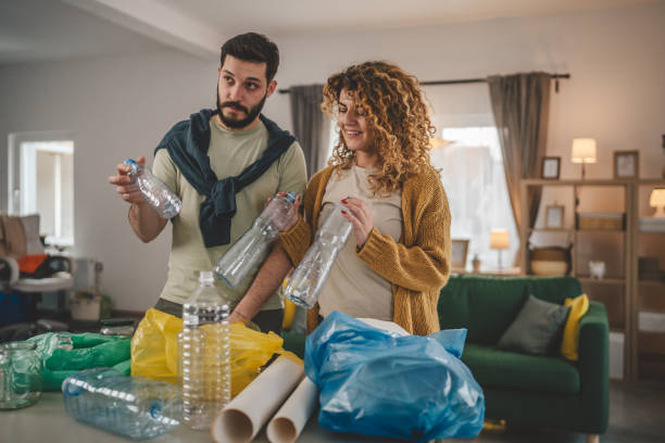 istock husband and wife recycle at home sorting waste plastic paper and glass 2013247950
