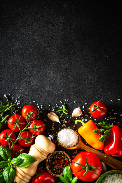 Food cooking background on black stone table.