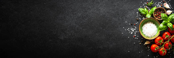 Food cooking background on black stone table.