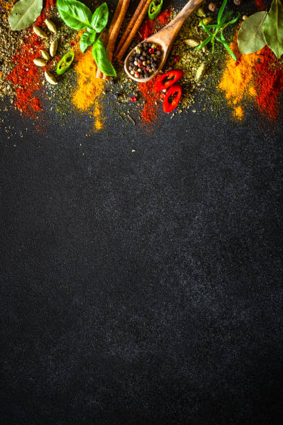 istock Spices and herbs on black slate background. 2013266796
