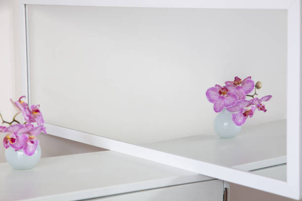 istock purple orchid in glass vase on white background 2013277937