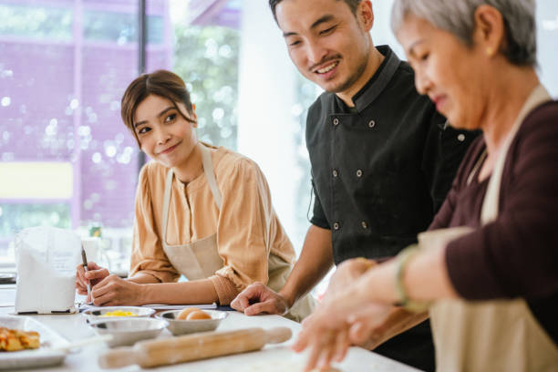 istock The Art of Pasta: Asian Students Perfecting Dough at Culinary School 2013288652