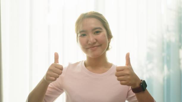 istock Asian woman thumbs up. 2013293416