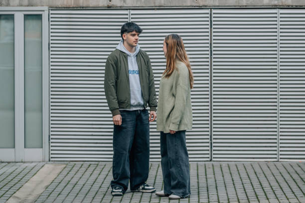 istock boy and girl 20s talking on the street 2013298152