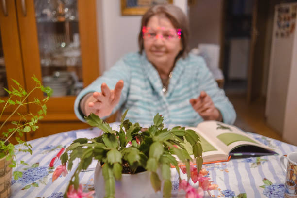 One active elderly woman learning about plant and botany via VR glasses