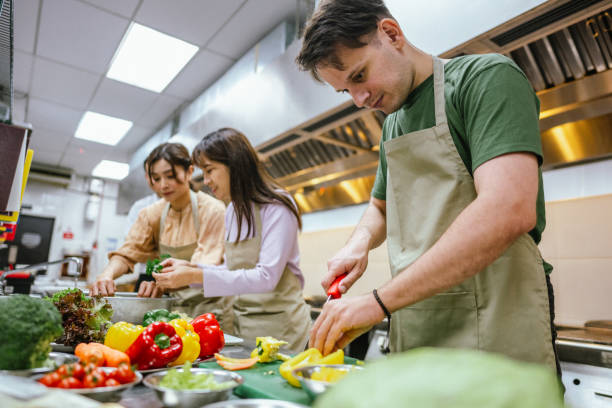 istock Culinary Collaboration: Multiracial Group of Adult Students Master Team Cooking Class 2013308842