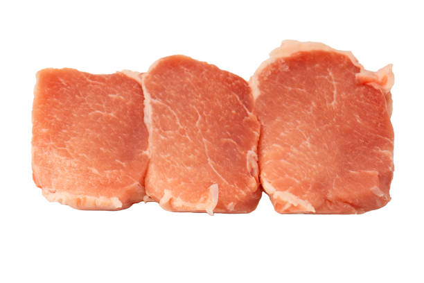 Raw pork pieces isolated on a white background. Top view.