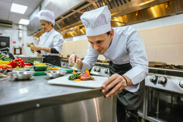 istock Crafting Culinary Masterpieces:  Male Student's Expertise in Food Decoration 2013314848