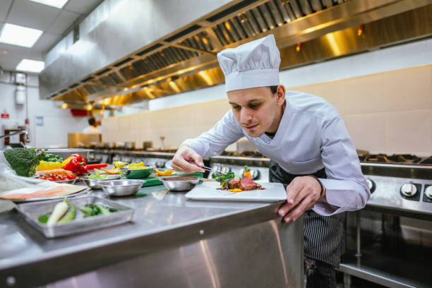 istock Crafting Culinary Masterpieces: Male Student's Expertise in Food Decoration 2013315907