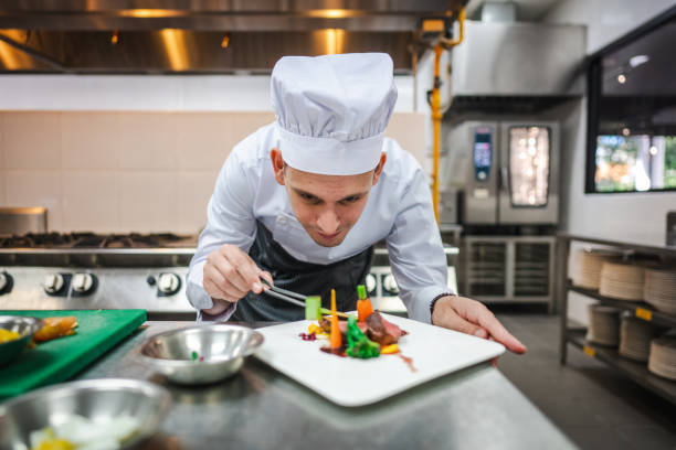 istock Exploring Culinary Creativity:  Male Student Demonstrates Food Decoration Techniques 2013315908