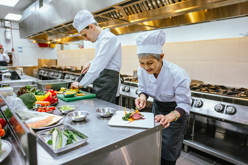 Culinary Mastery: Asian Senior Female Student Excels in Food Decoration Techniques During Cooking Class - Curriculum Education Training - Meals and Food Preparation