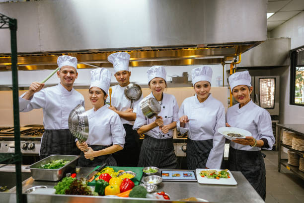 istock Unity in Culinary Craft: Asian Male Chefs and Students Flourish in Cooking Class Training 2013327656