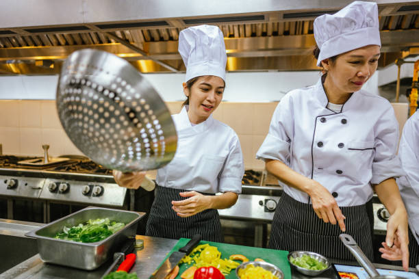 istock Multiracial Group of Adult Students Master Team Cooking Class - Culinary Collaboration: 2013329281