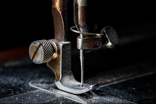 Macro detail of vintage sewing machine needle