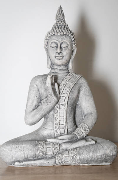 istock Zen Decor: Wooden Table with Buddha Statue in Meditation Pose 2013343293