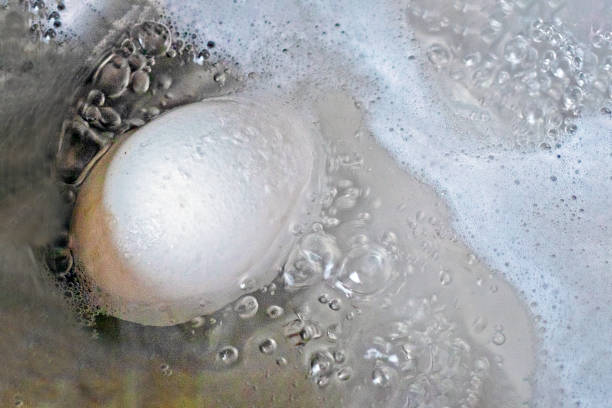 istock close-up of a chicken white egg boiled in boiled water 2013345552