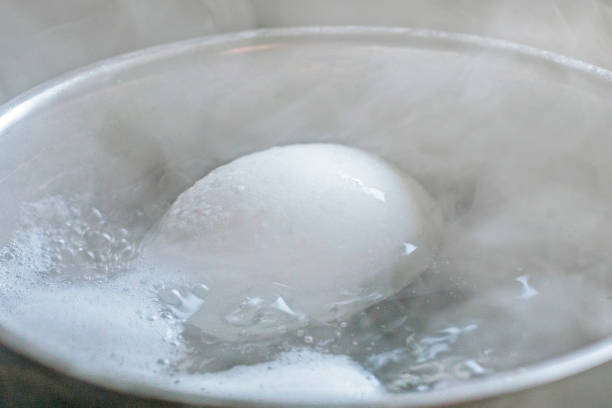 istock close-up of a chicken white egg boiled in boiled water 2013346086