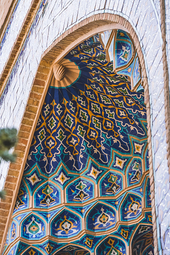 Facade of the Gur Emir mausoleum with mosaic brick walls in the ancient city of Samarkand in Uzbekistan, oriental architecture