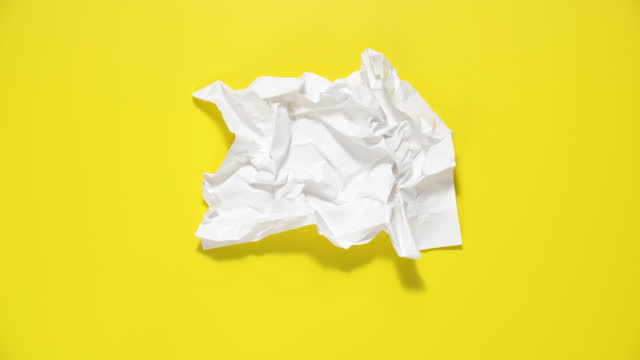 Stop motion animation of crumpled paper, stop motion animation 4k, on a yellow background.
