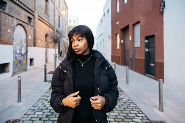 istock Young woman walking on the street. 2013379730