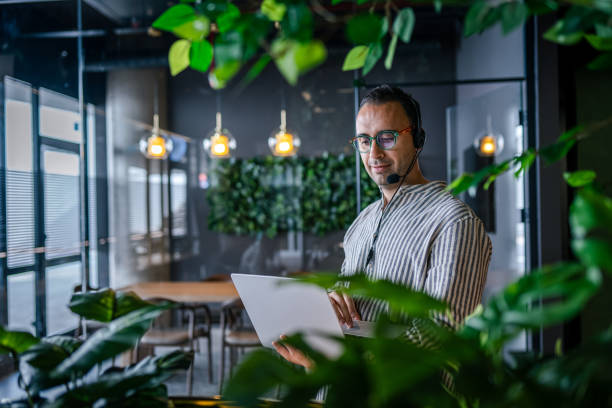 istock Portrait of a Handsome young man working in a call center 2013409507