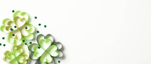 istock Paper four leaf clover with confetti on white background. St Patrick's Day banner design. 2013444683