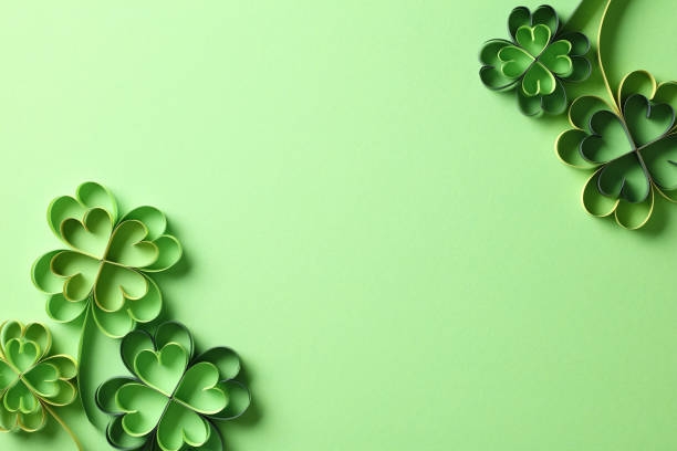 istock Flat lay composition with four leaf clover paper art on green background. St Patrick's Day concept. 2013449443