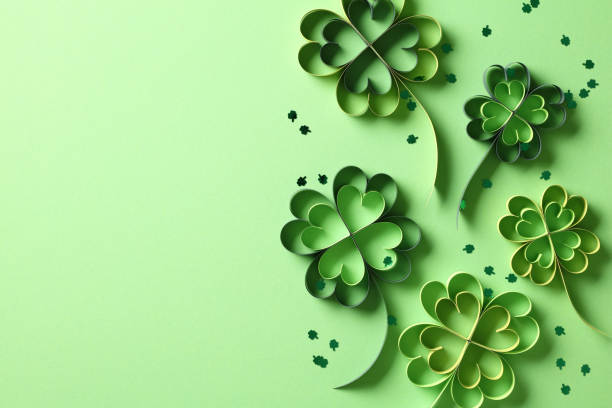 istock St Patrick's Day holiday background with four leaf clover paper art and confetti. Top view. 2013452610