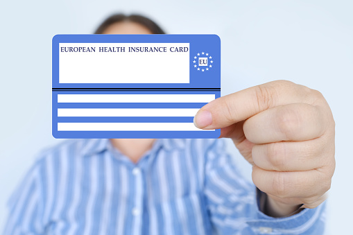 electronic public health insurance cheaper, Insurance Card EU in female hand, concept medical support on trip to Europe, emergency treatment services, healthcare coverage abroad, card security