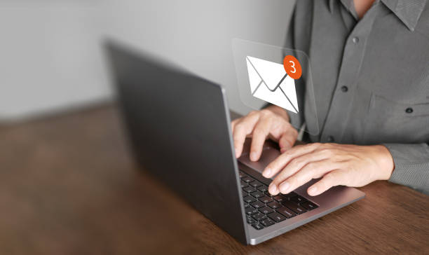 istock Email or electronic mail concept. A man uses computer laptop to send and receive online messages with email inbox icons, email marketing and newsletter. 2013510757