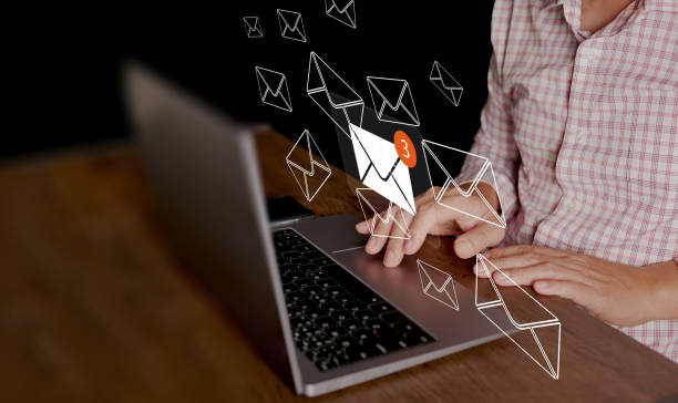 istock Email or electronic mail concept. A man uses computer laptop to send and receive online messages with email inbox icons, email marketing and newsletter. 2013510761