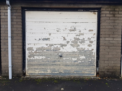 A weathered white coloured garage door, Glasgow Scotland England UK