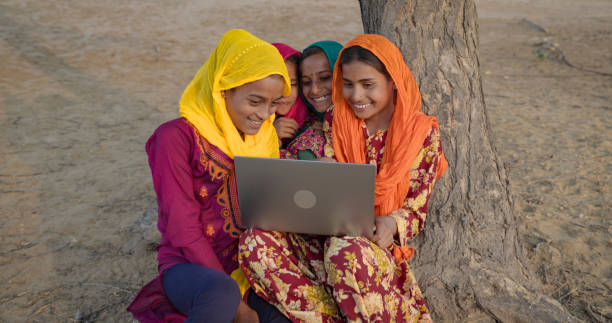 istock Happy Indian girls using laptop, India 2013549567