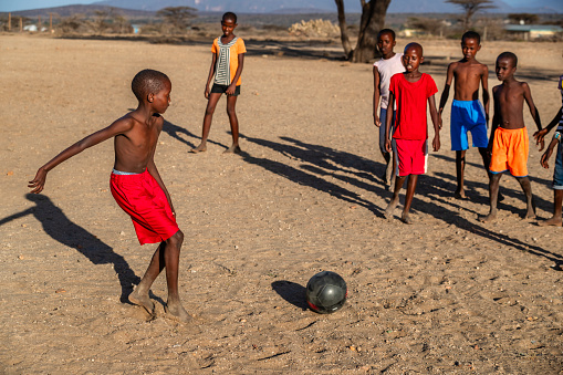 African children from Samburu tribe playing football in the village, Kenya, East Africa. Samburu tribe is north-central Kenya, and they are related to  the Maasai.
