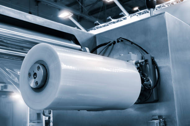 istock Automatic polyethylene plastic bag production machine with lighting effect. Close-up of the roller of the plastic bag production machine in the light blue scene. product packaging concept 2013617476