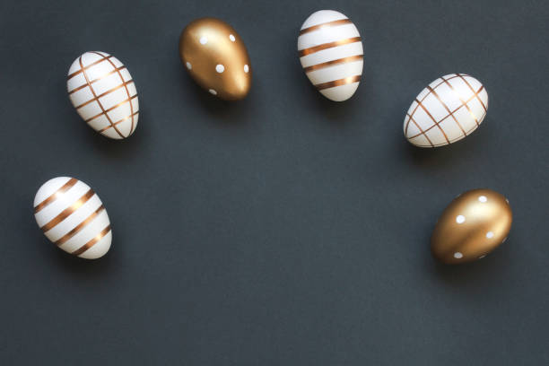 istock Luxury Easter eggs decorated with gold arranged in a semicircle on dark gray blue background with copy space 2013675867