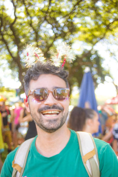 istock reveler in the block smiles with carnival props 2013678963