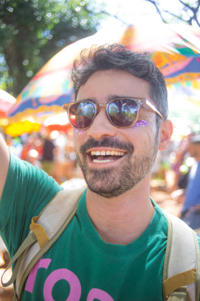istock reveler in the block smiles with carnival props 2013678965