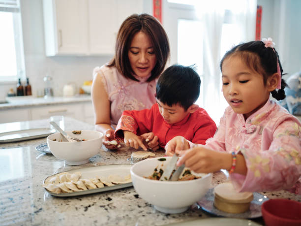 istock Chinese Family Making Jiaozi Dumplings 2013700493