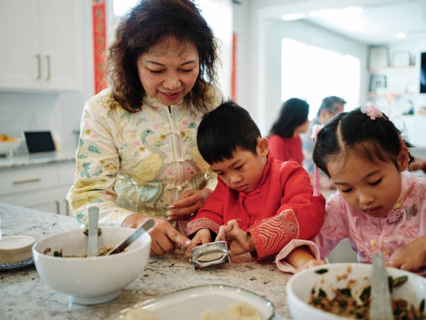 istock Chinese Family Making Jiaozi Dumplings 2013701513