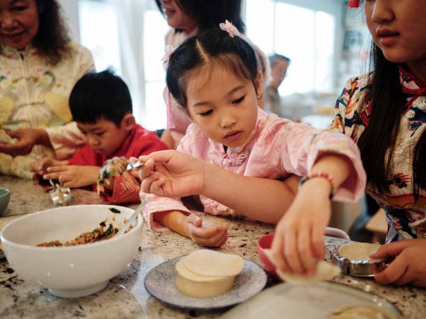 istock Chinese Family Making Jiaozi Dumplings 2013704100