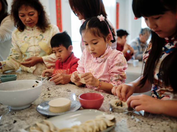 istock Chinese Family Making Jiaozi Dumplings 2013704629