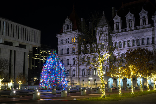Albany, USA - December 21, 2023. Christmas tree at Capital Complex of Empire State Plaza at night in the downtown Albany, New York, USA