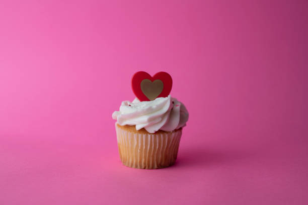 istock White Valentine´s CupCakes with Pink Background. 2013766635