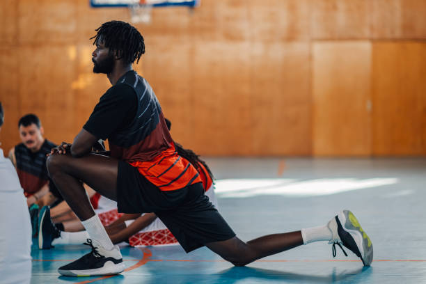 istock Side view of an interracial basketball player stretching on training. 2013811819