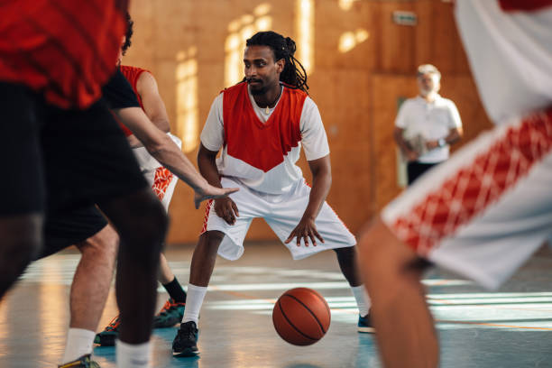 istock An interracial basketball player is dribbling a ball in crowd at training. 2013811821