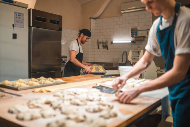 istock Caucasian Artisan Bakers Shaping Pastries In A Small Bakery 2013826278