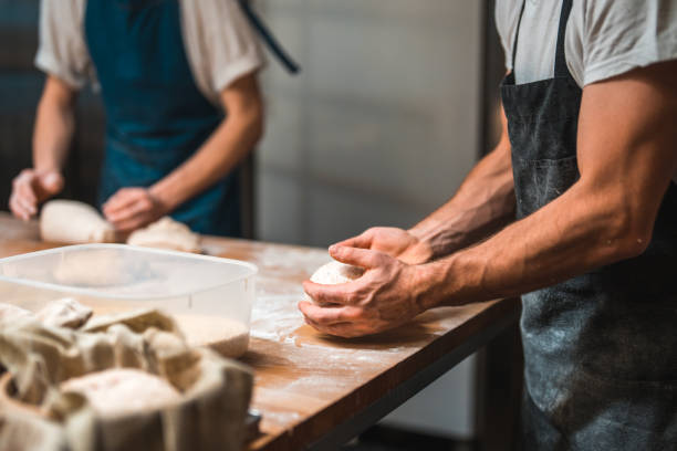 istock Artisan Baker Putting Bread Into Wicker Bowls For Proofing 2013826298